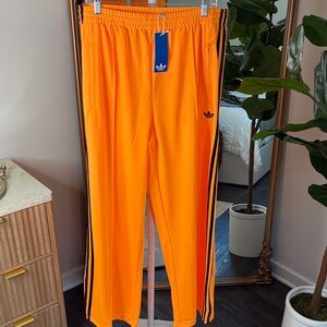 Adidas Women’s Bright Orange Pants with Black Stripes
